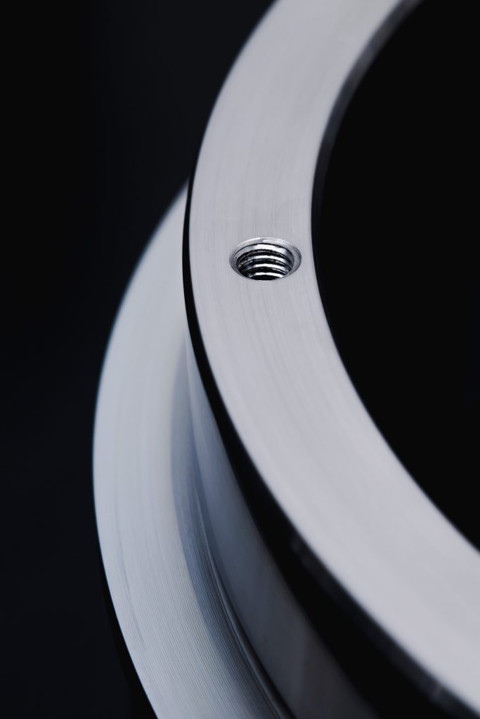 Industrial metal manufacturing process with machinery and workers in a factory